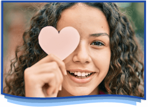 smiling girl holding a paper heart